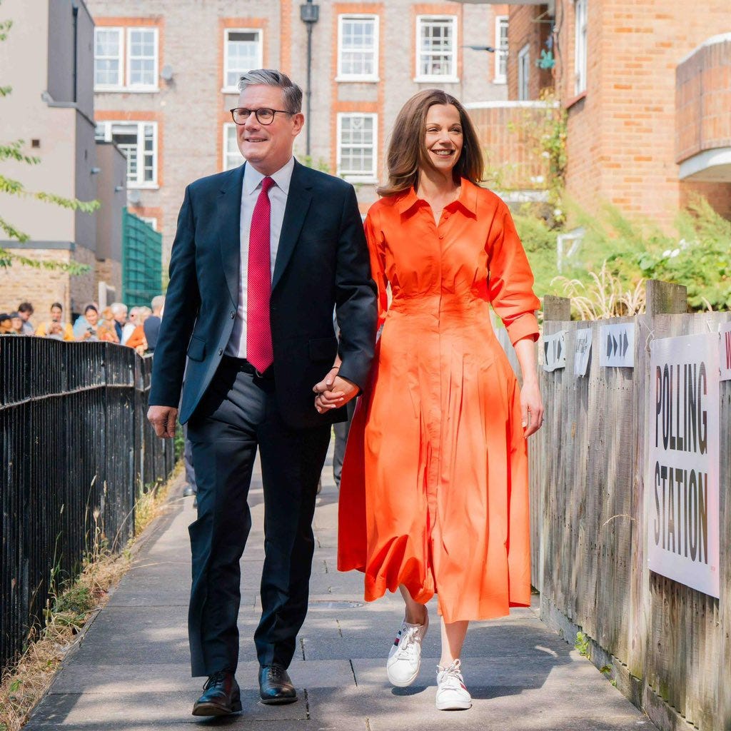 A photograph of Keir and Vic Starmer walking to their polling station to vote