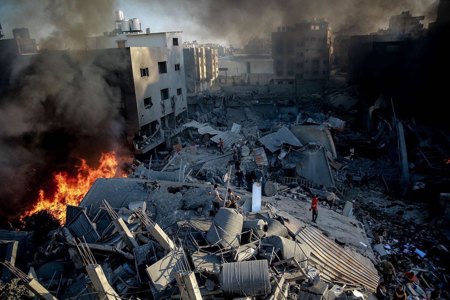 Smoke and fire rise from a leveled building in Gaza City.