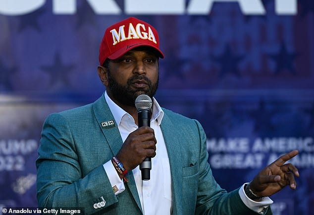 Patel wearing a MAGA hat while speaking on a Trump Bus Tour in Charlotte in October 2024