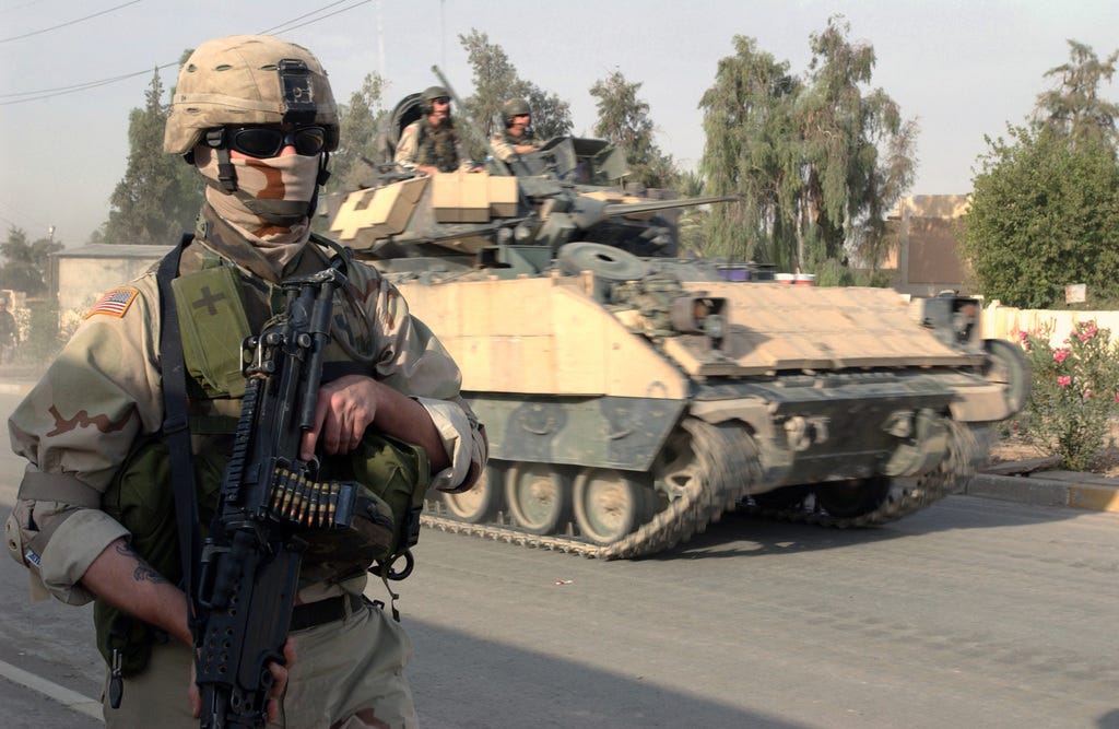 U.S. Army Soldiers, Charley Company, 1-26 Infantry Battalion, patrol the  streets on foot and in an M3A3 Bradley fighting vehicle at Samarra, Iraq,  Oct. 8, 2004, in support of Operation IRAQI FREEDOM. (
