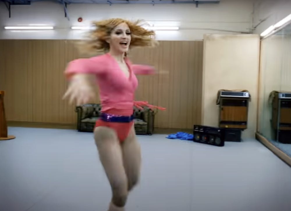 Madonna twirling in the video for hung up and smiling