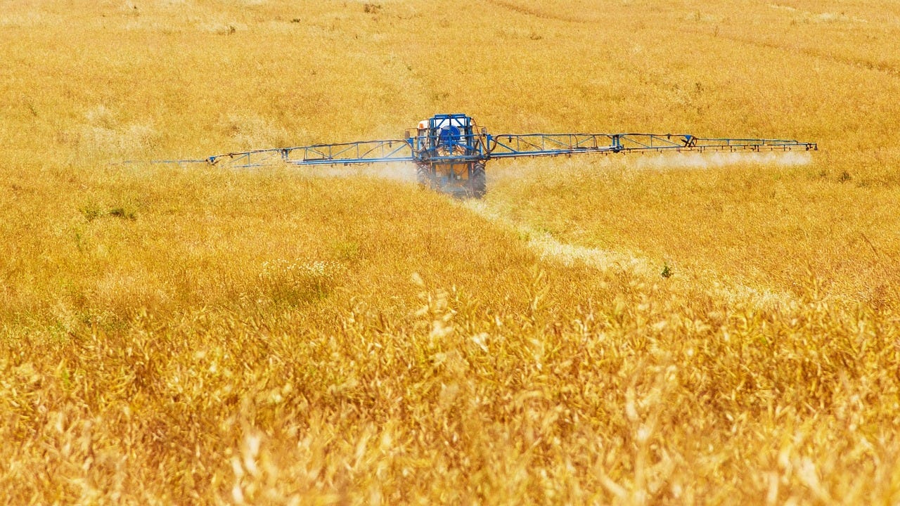 Tractor spraying fertilizer