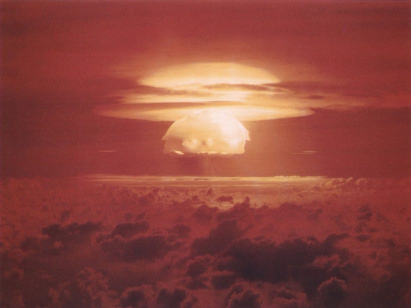 Red-hued image of a nuclear mushroom cloud