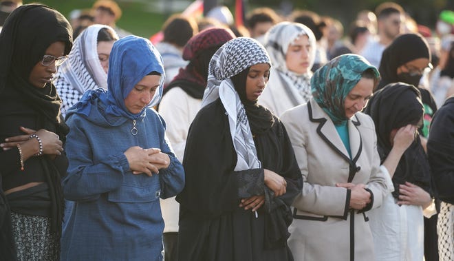 May 1, 2024; Columbus, Ohio, USA; Women pray during protests at The Ohio State University as demands are made for the university to divest from Israel over the Israel-Hamas War.