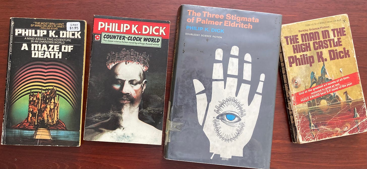 Book covers of four Philip K. Dick novels: A Maze of Death, Counter-Clock World, The Three Stigmata of Palmer Eldritch, The Man in the High Castle