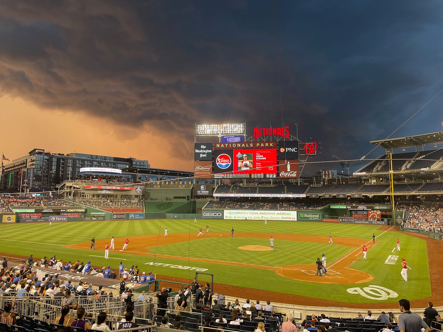 Stormclouds gather over a baseball diamond.