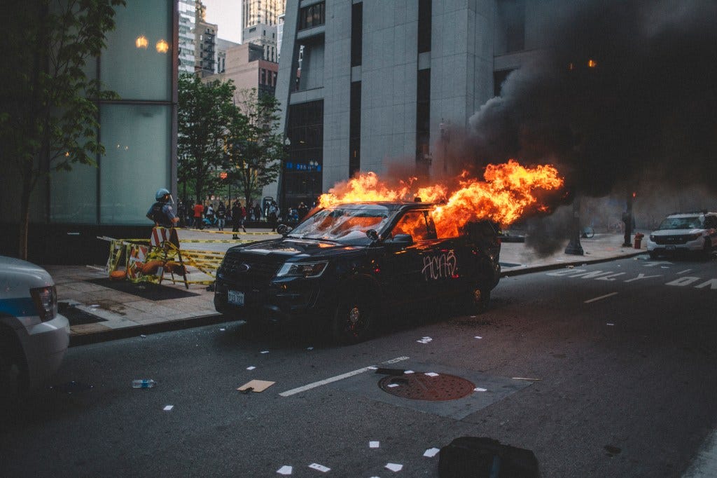 Protesters set fire to a police vehicle  , on May 30, 2020 during a protest against the death of George Floyd