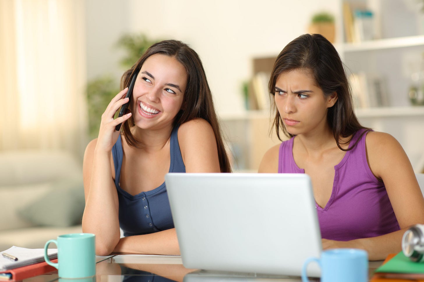 Suspicious student listening a friend talking on phone at home