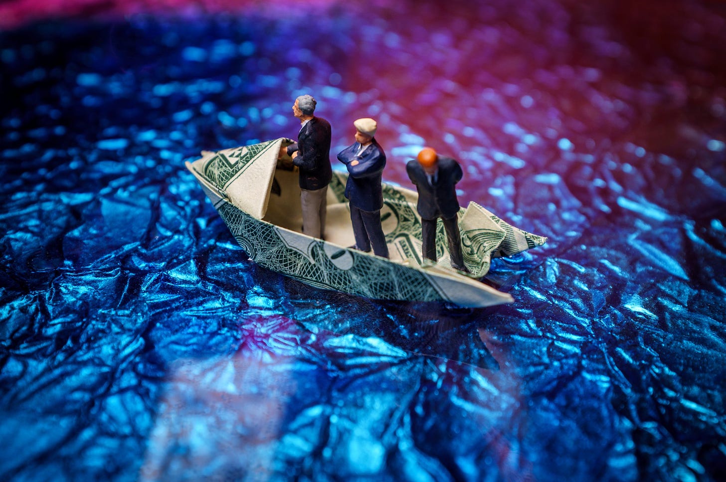 Miniature,Figurine,Businessmen,Ride,On,Dollar,Bill,Origami,Yacht