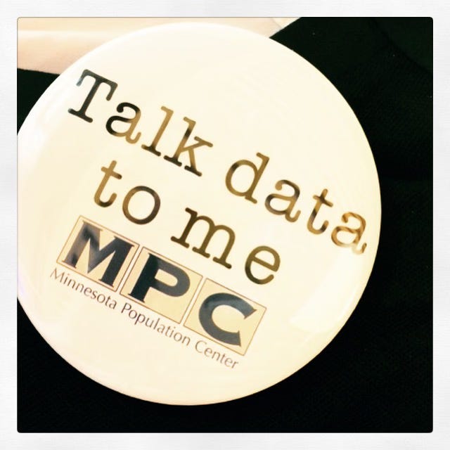 Photo of a button that reads Talk Data to Me from the Minnesota Population Center