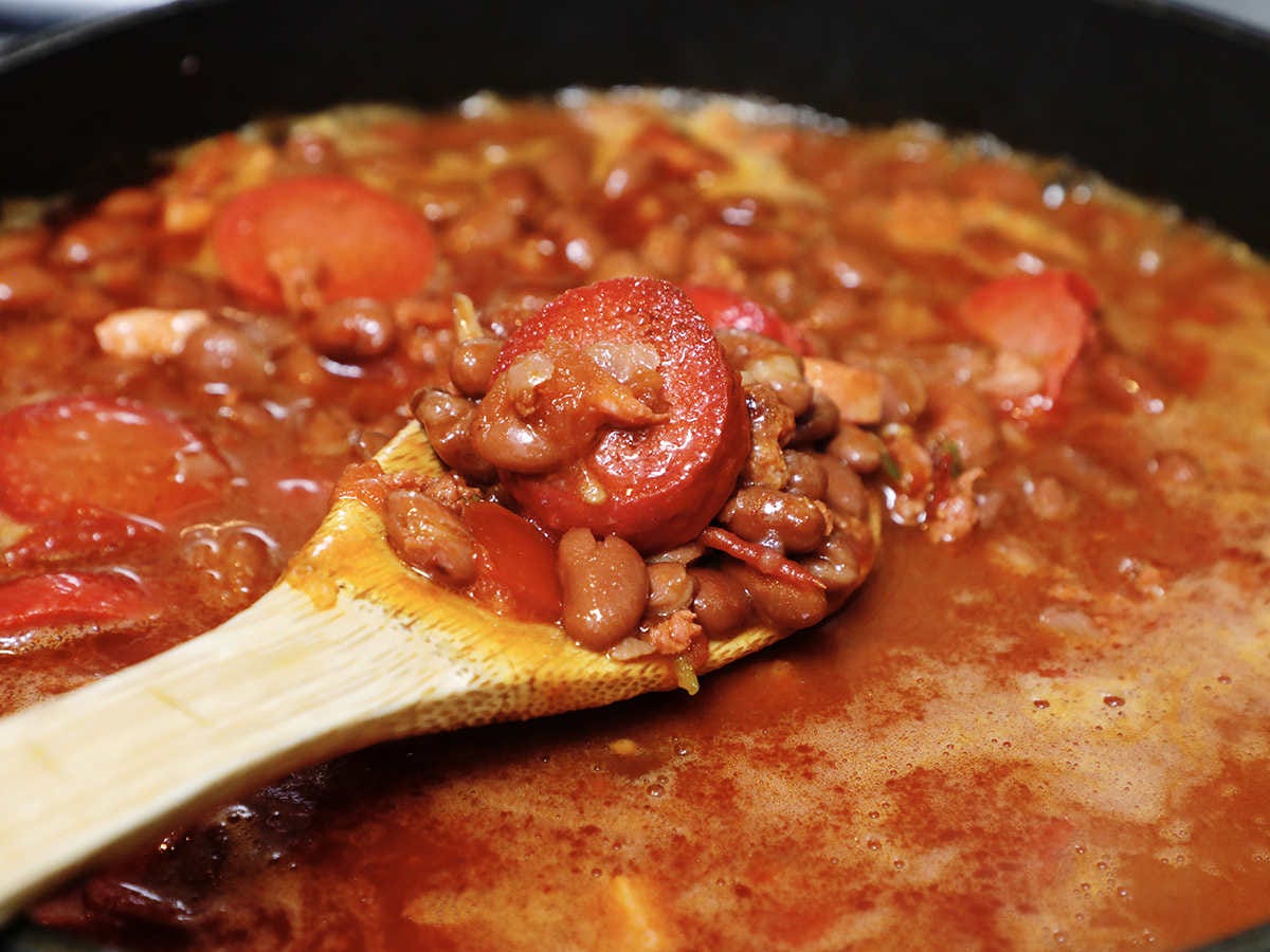 frijoles charros on wooden spoon