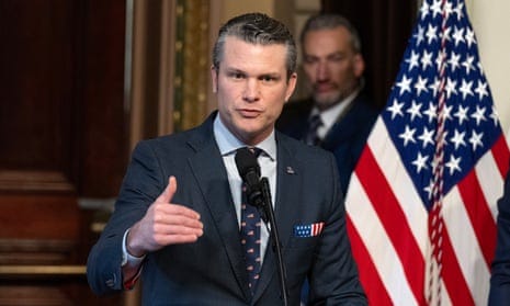 Pete Hegseth speaking from a podium, US flag in the background Pete Hegseth speaking from a podium, US flag in the background
