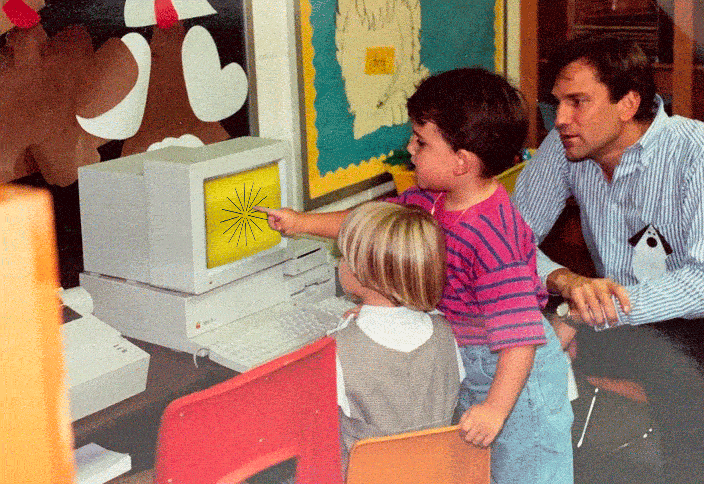 A photo of me in a classroom as a child in the 90s, leaning over the shoulder of a friend, at a CRT computer monitor. On the screen is an animated image with a starburst, the words "thank you for subscribing", and then a smiley face.