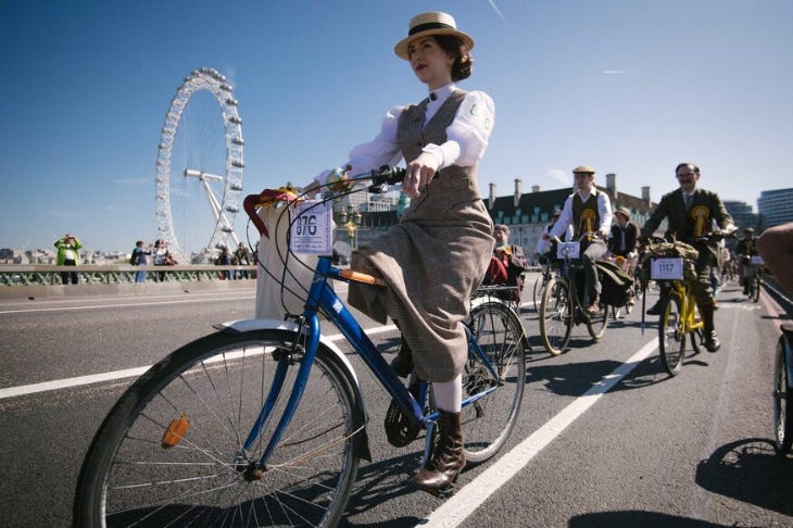 Cyclists wearing tweed riding over Westminster Bridge Cyclists wearing tweed riding over Westminster Bridge