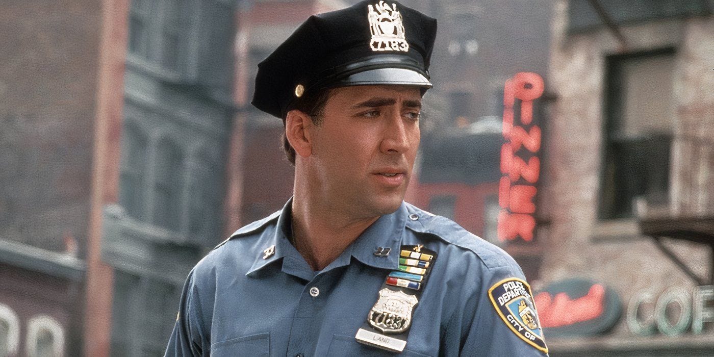 Nicolas Cage as Charlie wearing a cop uniform and hat outside in 'It Could Happen to You'