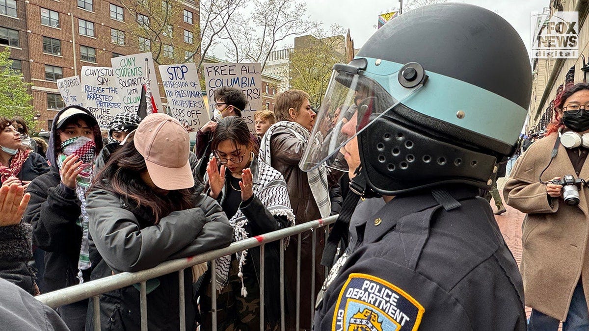 NYPD officers patrol as pro-Palestine protestors demonstrate outside of Columbia University’s campus