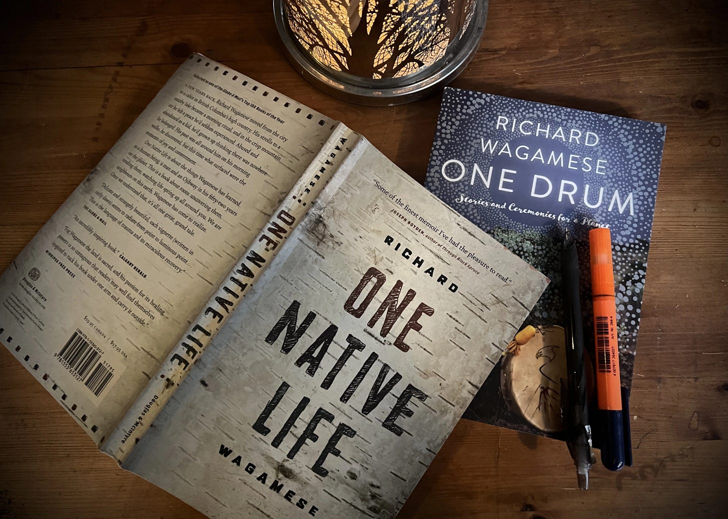 Books One Native Life and One Drums lie open on a table.