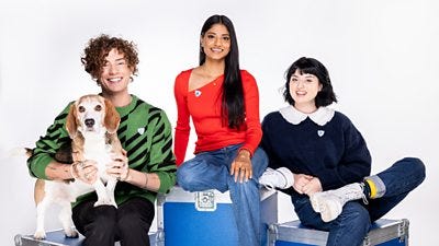 Henry the Dog, Joel Mawhinney, Shini, Abby Cook smiling to camera