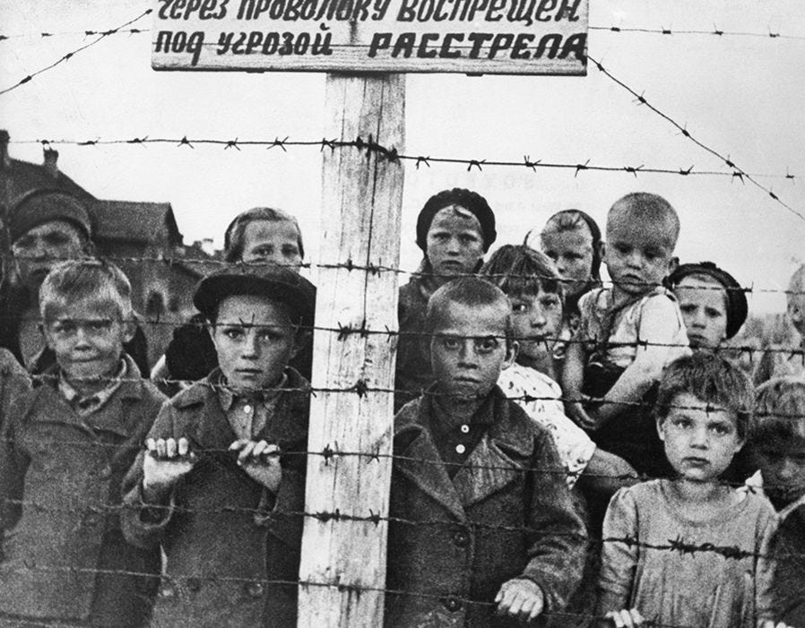 Children behind barbed wire in a German concentration camp set up in ...