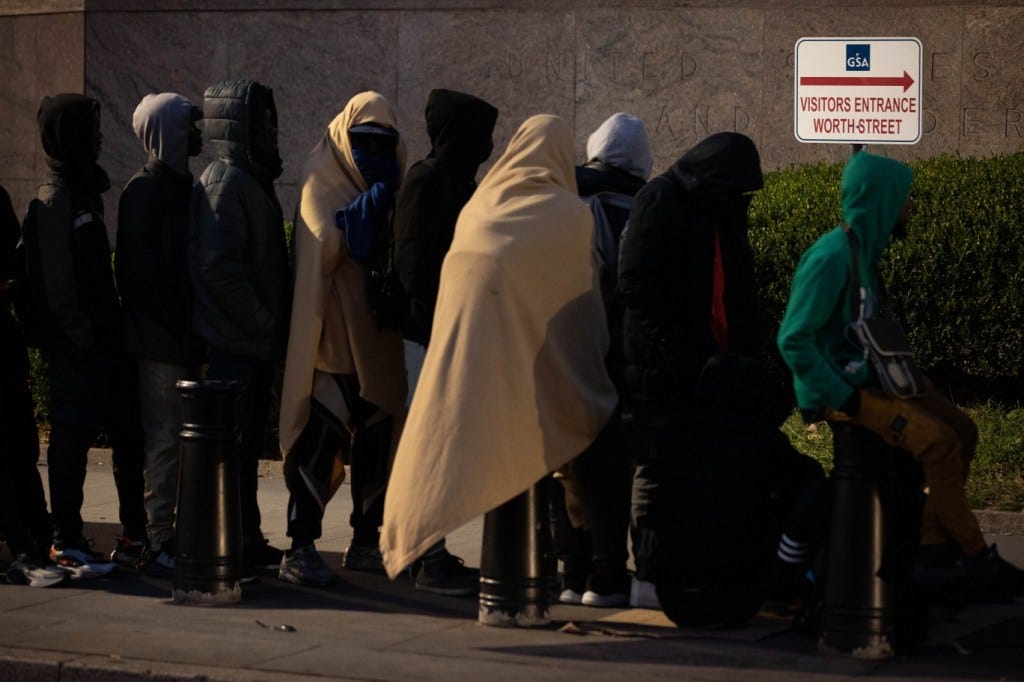 Migrants are seen waiting to get into 26 Federal Plaza in Manhattan on Oct. 23, 2023.