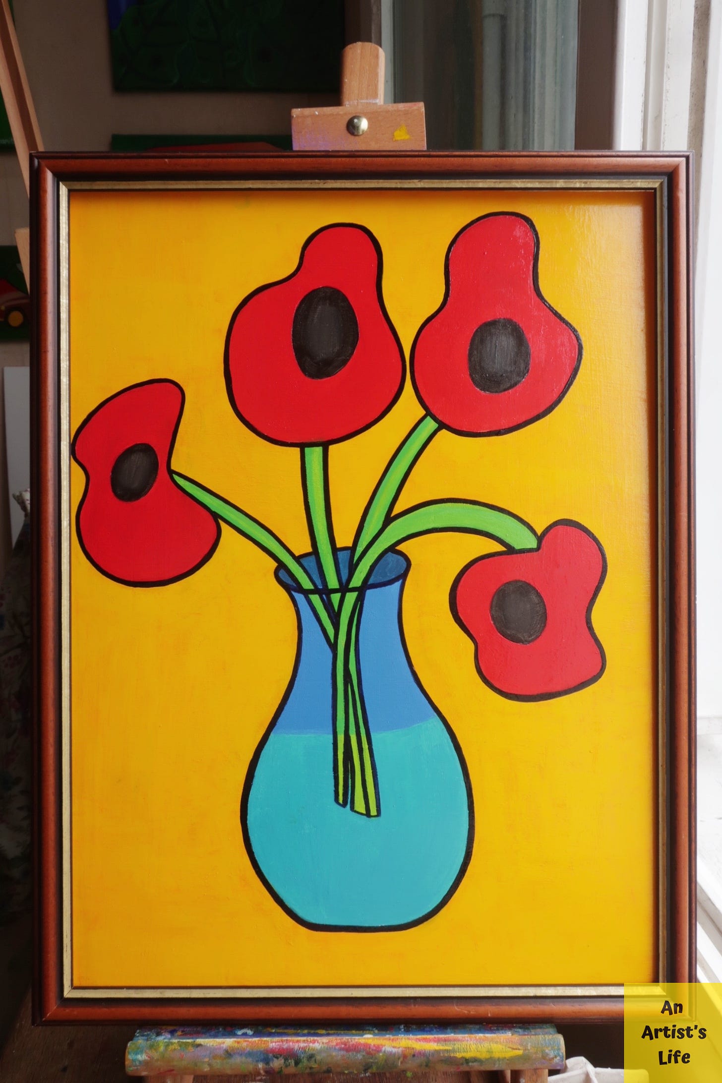 A wooden framed oil painting of four poppies in a blue vase on a yellow background