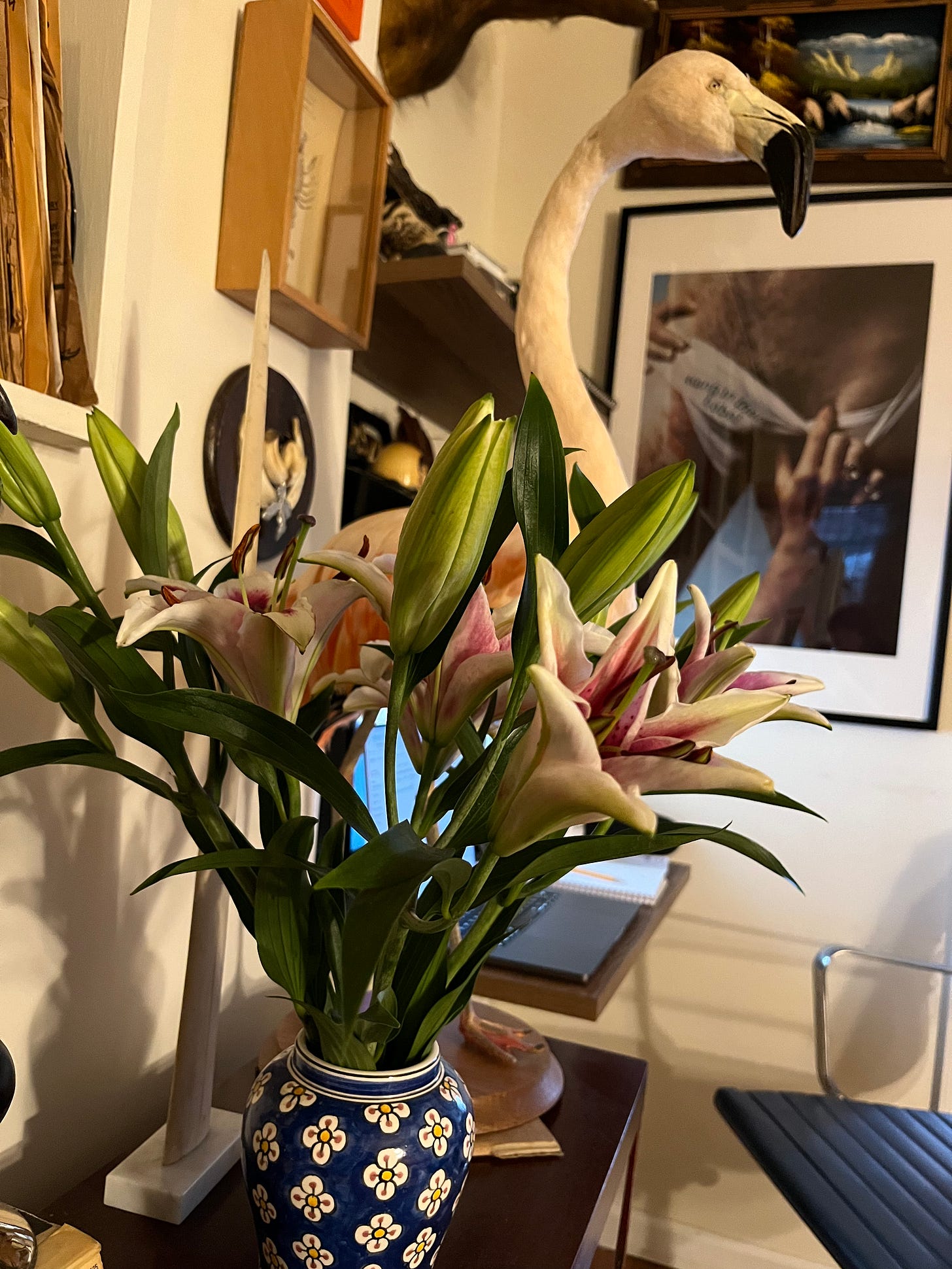 A bouquet of Stargazer Lilies in front of a taxidermy flamingo