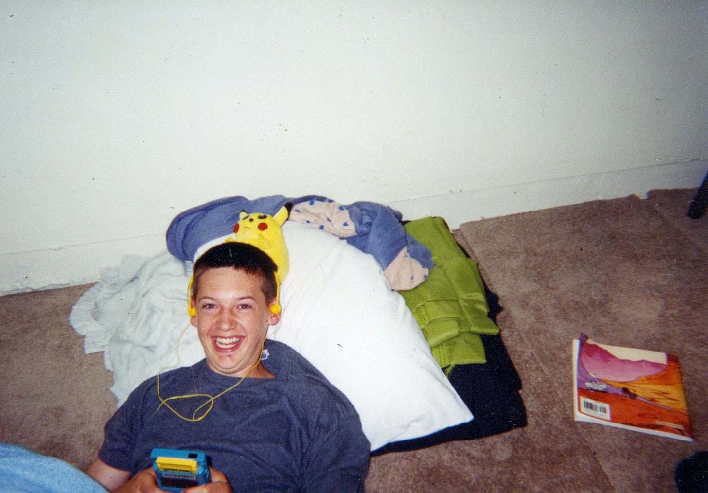 A photograph of Erchon when he was just 16 years old, playing Pokémon Yellow on his Game Boy Color