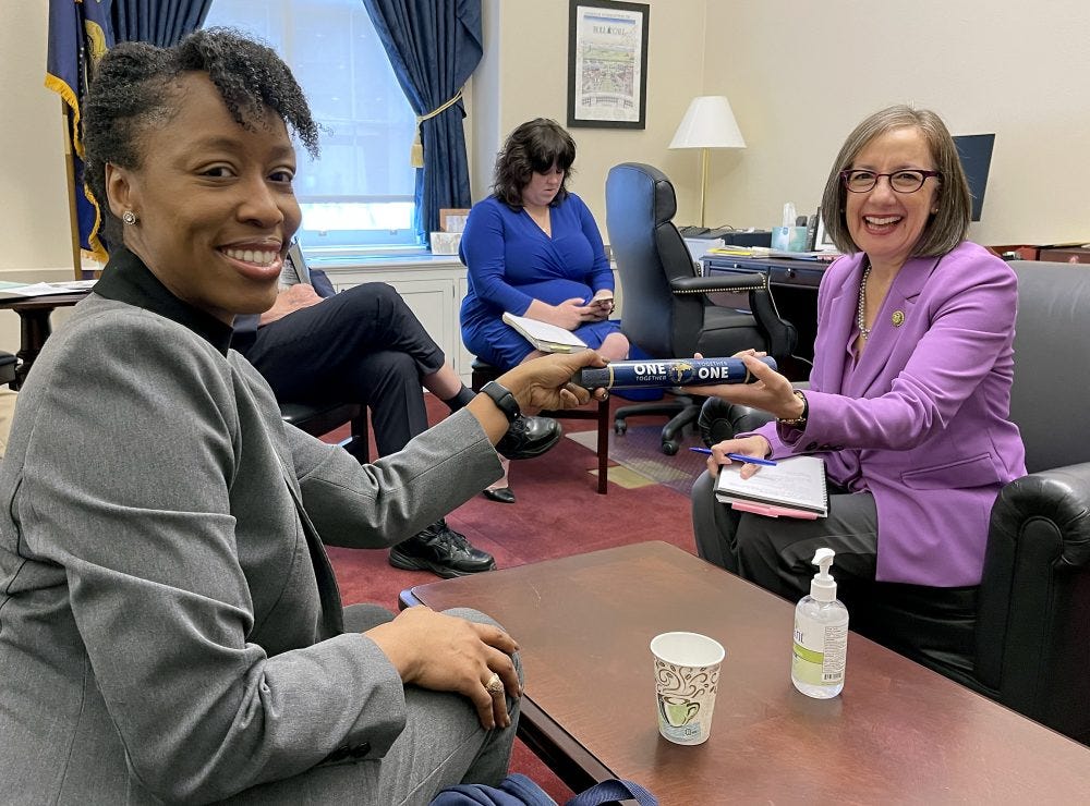 Andrea Salinas receives one of Dr. Bennings' patented track batons.