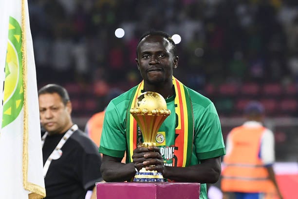 Senegal's forward Sadio Mane holds the trophy prior to the ceremony after winning after the Africa Cup of Nations 2021 final football match between...