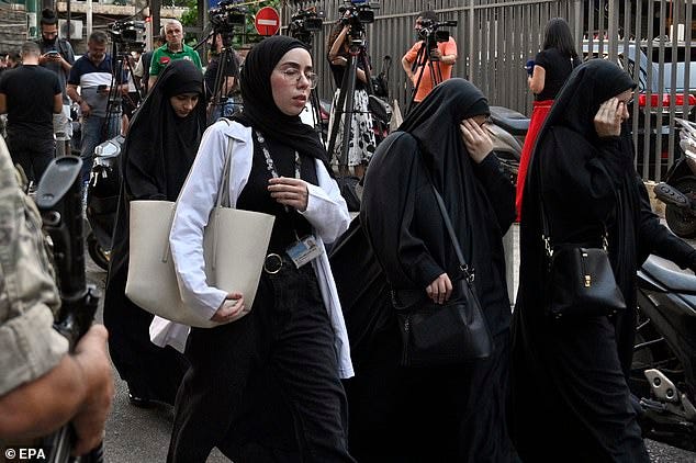 Friends and relatives of injured people arrive at the American University of Beirut Medical Center (AUBMC) after an incident involving Hezbollah members' wireless devices in Beirut, Lebanon