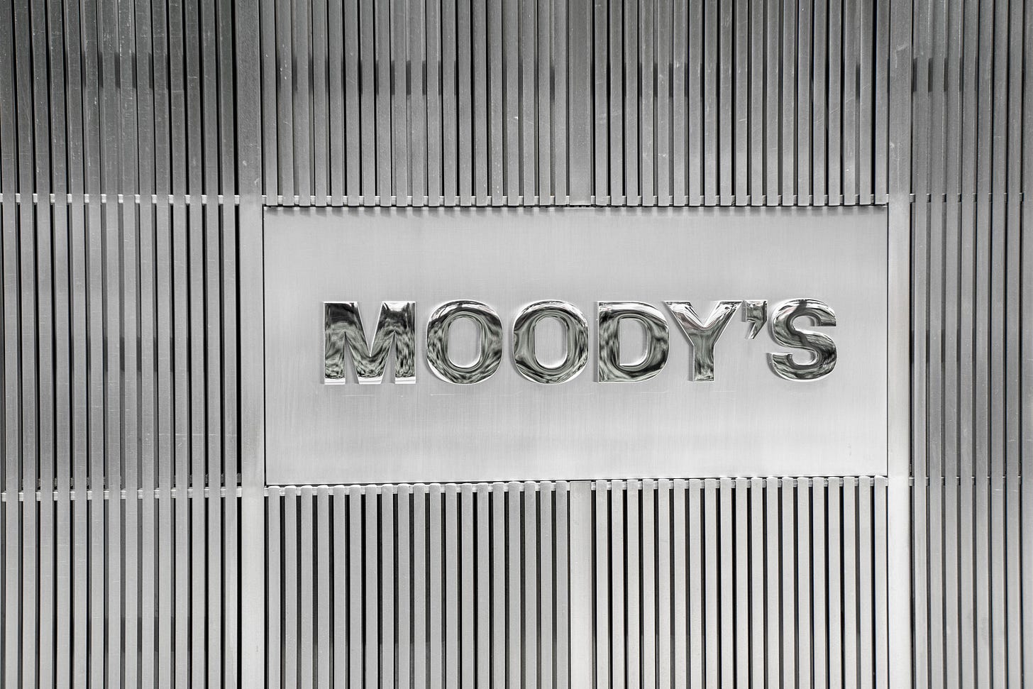 A placard reading “Moody’s” on the façade of a building.