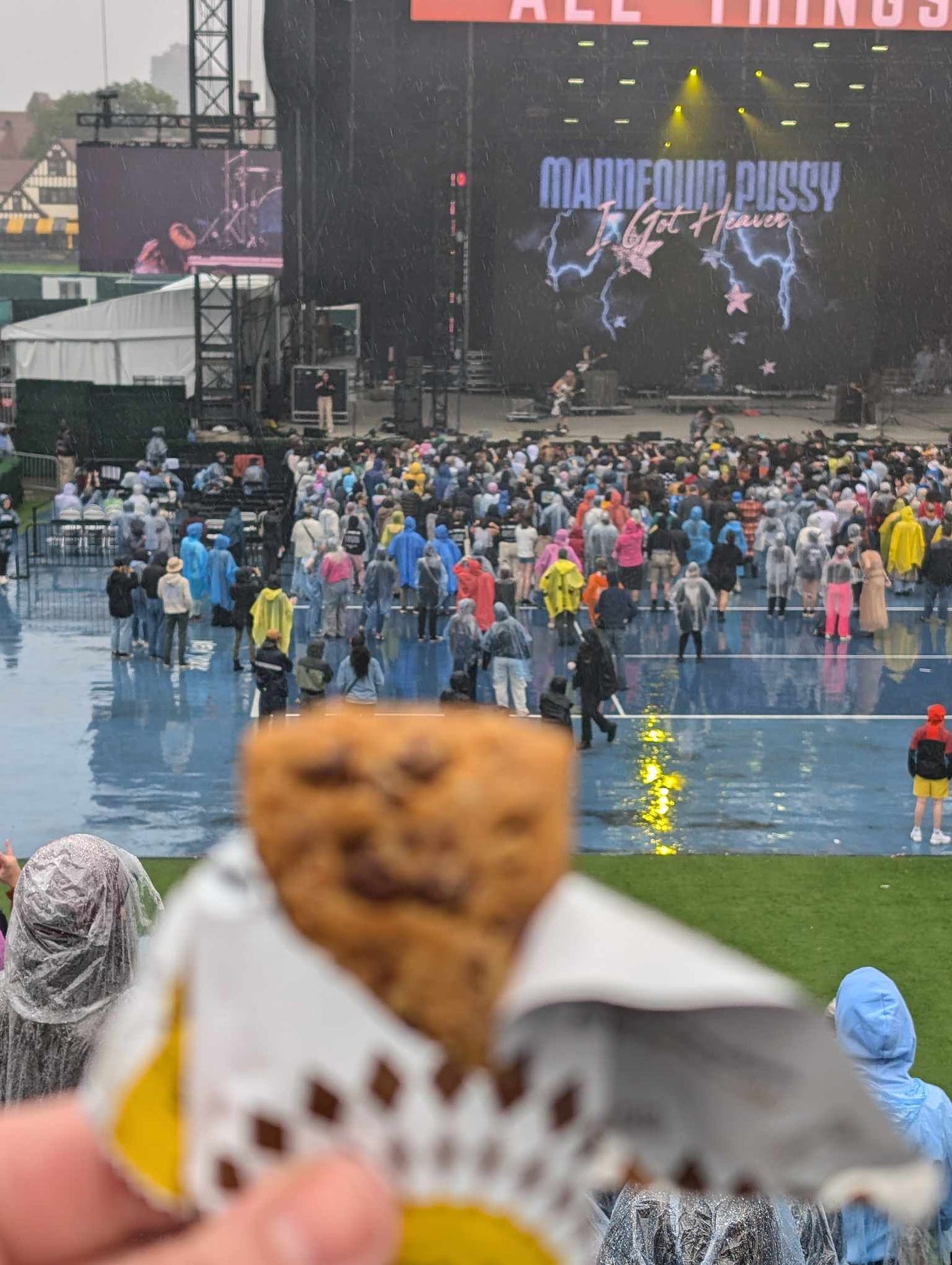 a blurry granola bar is held up to  a stage