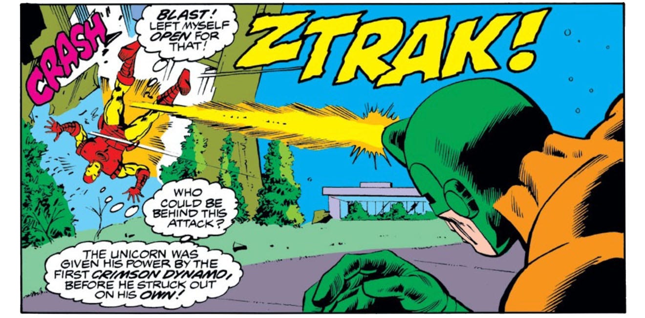 A panel from this issue showing the Unicorn blasting Iron Man with his "energy horn." There's a sound effect "ZTRAK!" from the blast and a "CRASH" as Iron Man is knocked into a building. While this is going on, Iron Man thinks "Blast! Left myself open for that! Who could be behind this attack? The Unicorn was given his power by the first Crimson Dynamo, before he struck out on his own!"