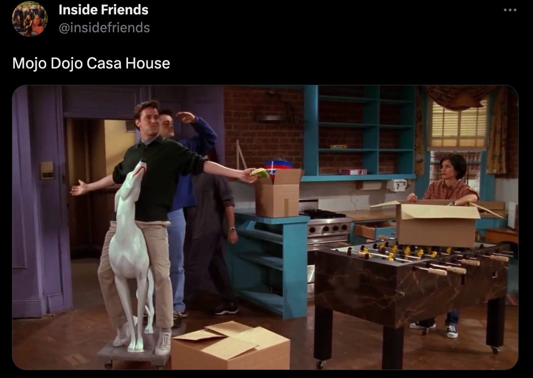 Tweet from @insidefriends that says "Mojo Dojo Casa House" and is an image of Chandler and Joey riding their giant white dog into Monica and Rachel's apartment. Monica is packing a box on top of their foosball table.