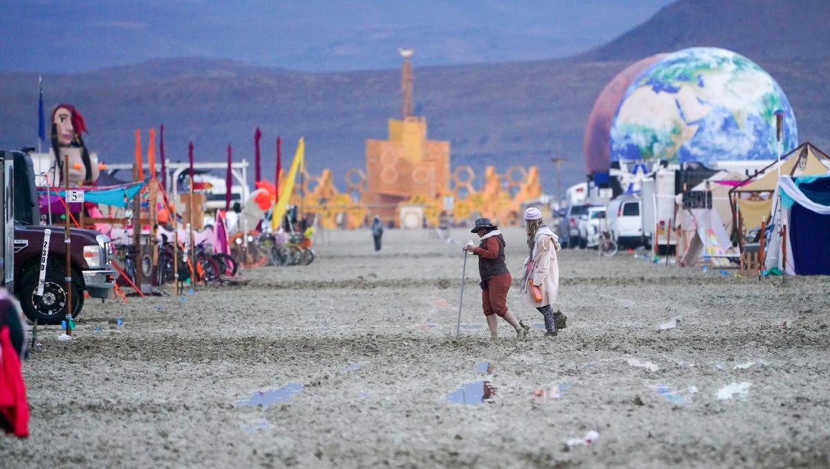 Dawn brought muddy realization to the Burning Man encampment, where the exit gates remain closed indefinitely.