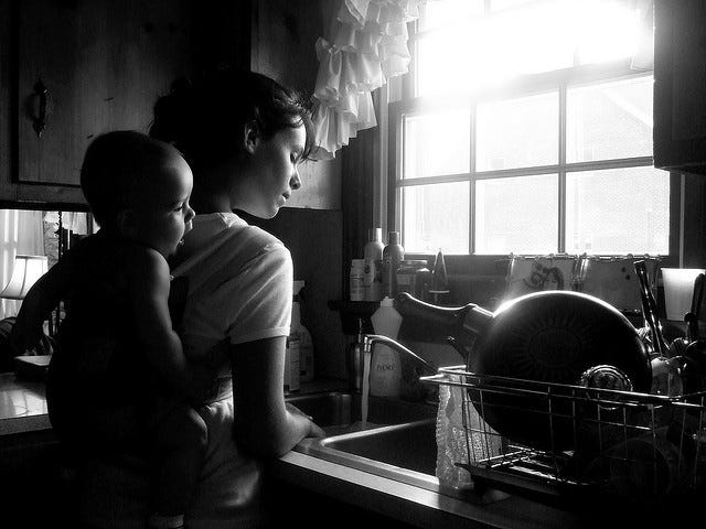 This may contain: a woman and child are in the kitchen