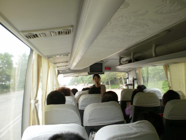 My North Korean tour guide instructing us not to take photos during the bus ride (August 2010).