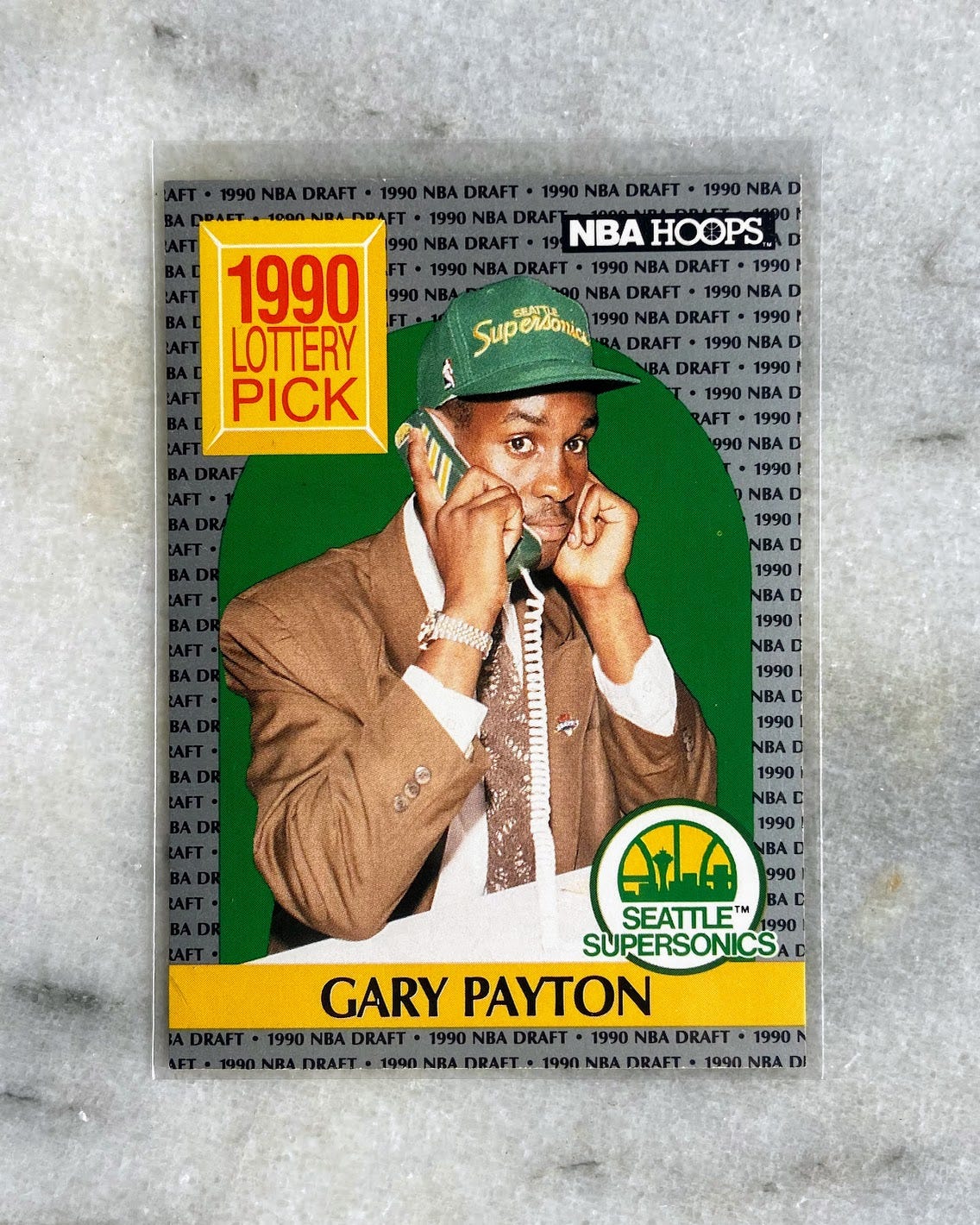 A 1990 basketball card featuring Gary Payton on the phone right after being drafted by the Seattle Supersonics