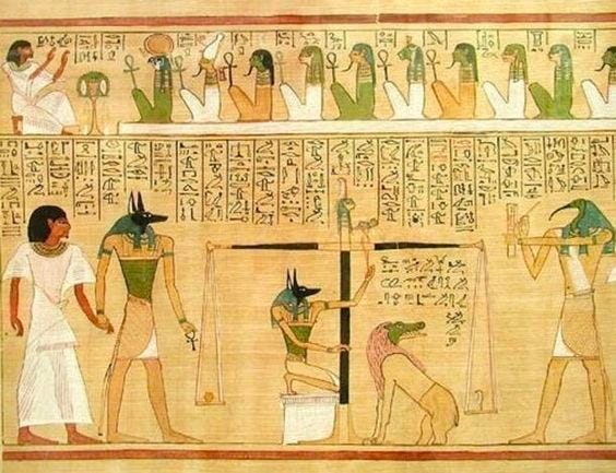 Egyptian hieroglyphics of Anubis weighing a heart against a feather while Ammit waits for the judgement. Thoth observes and writes, and another Anubis leads a man onto the scene. More gods and figures preside above the scene.