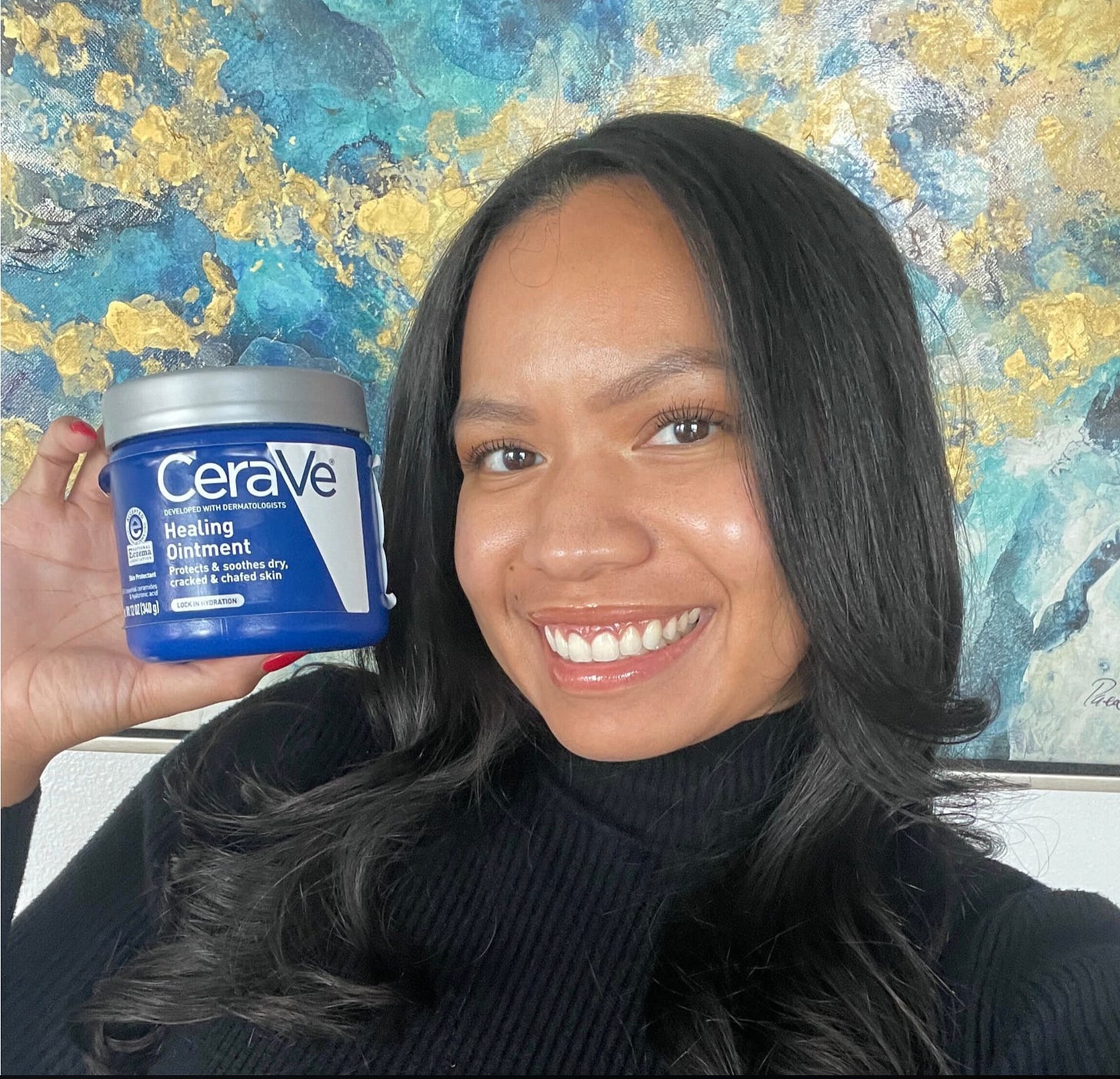 Woman smiling and holding a jar of CeraVe