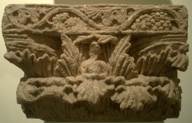 Pillar capital from Surkh Kotal, with central Buddha figure.
