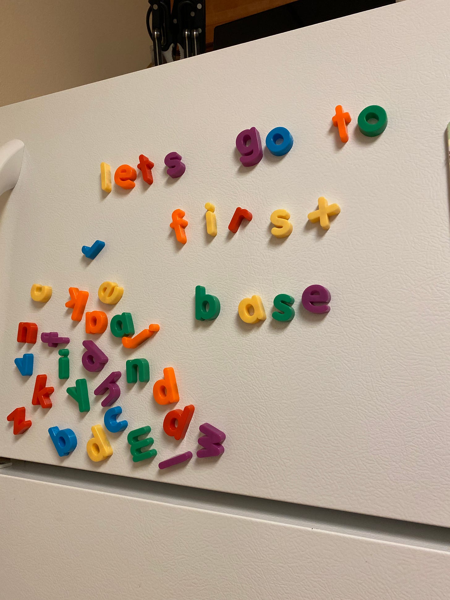 Photo of fridge, alphabet letters read, "lets go to first base"