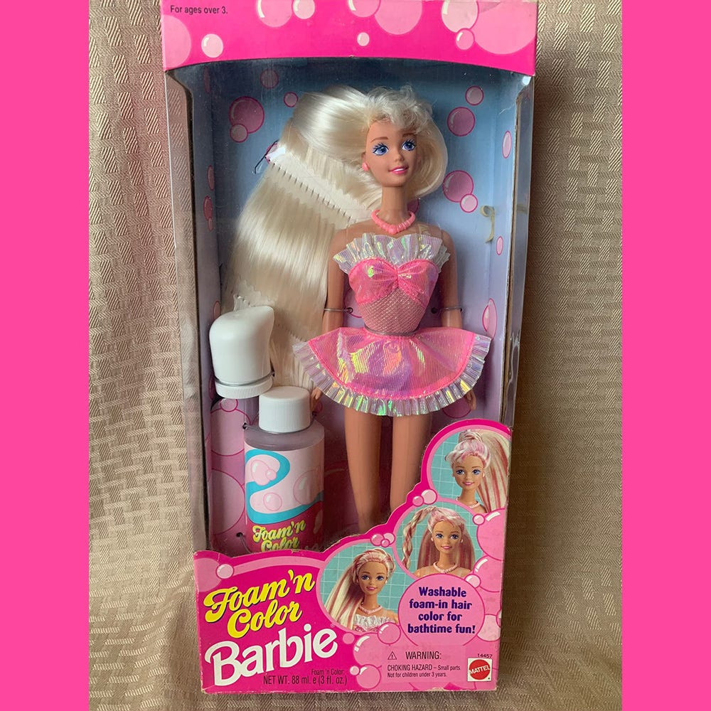 Foam n Colour Barbie pictures insider her box with a shiny pink and white mini dress, long blonde hair and a bottle of pink hair mouse that changed her hair colour