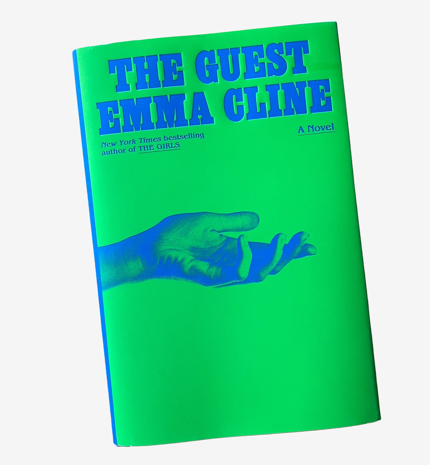 Hardcover edition of The Guest by Emma Cline (title and author in royal blue text against an electric green background, with an outstretched hand in royal blue emerging from the left side of the cover)