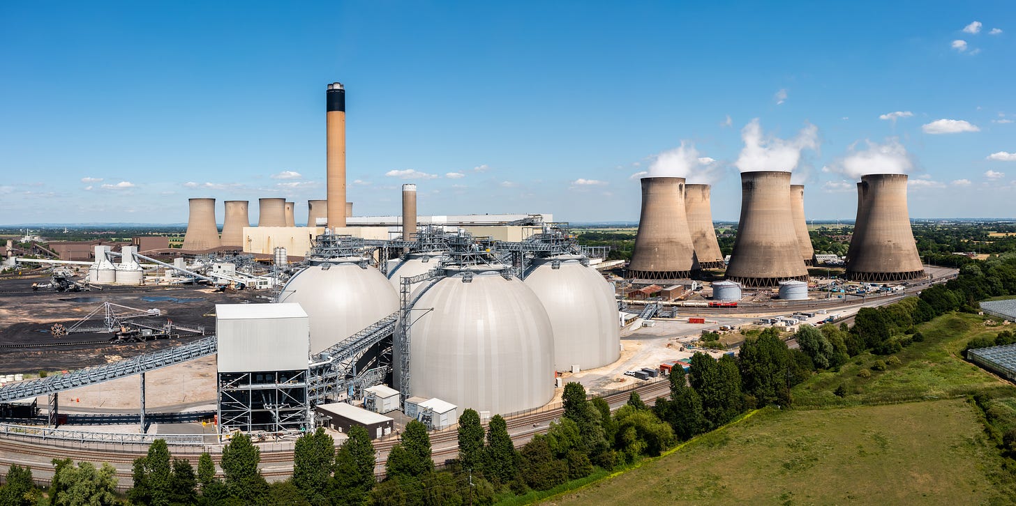 Aerial landscape view of a large coal fired power plant with storage tanks for Biofuel burning instead of coal