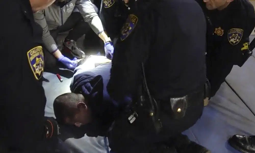 FILE - In this image taken from a nearly 18-minute video taken by a California Highway Patrol sergeant, Edward Bronstein, 38, is taken into custody by CHP officers on March 31, 2020, following a traffic stop in Los Angeles. Lawyers say California will pay a $24 million civil rights settlement to the family of a man who died after screaming "I can't breathe" while multiple officers restrained him as they tried to take a blood sample following his arrest. (California Highway Patrol via AP, File)