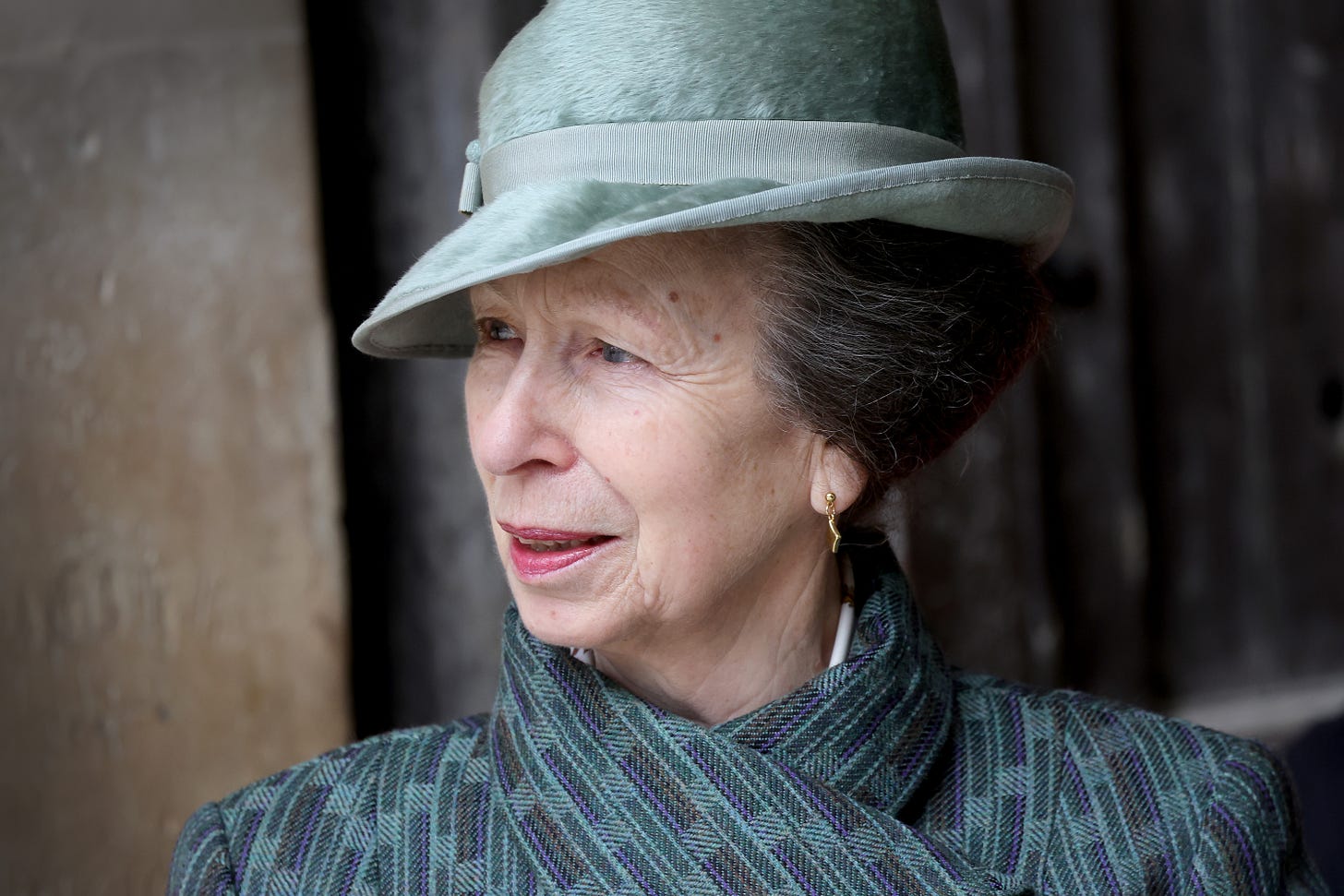 Close-up of Princess Anne wearing green hat