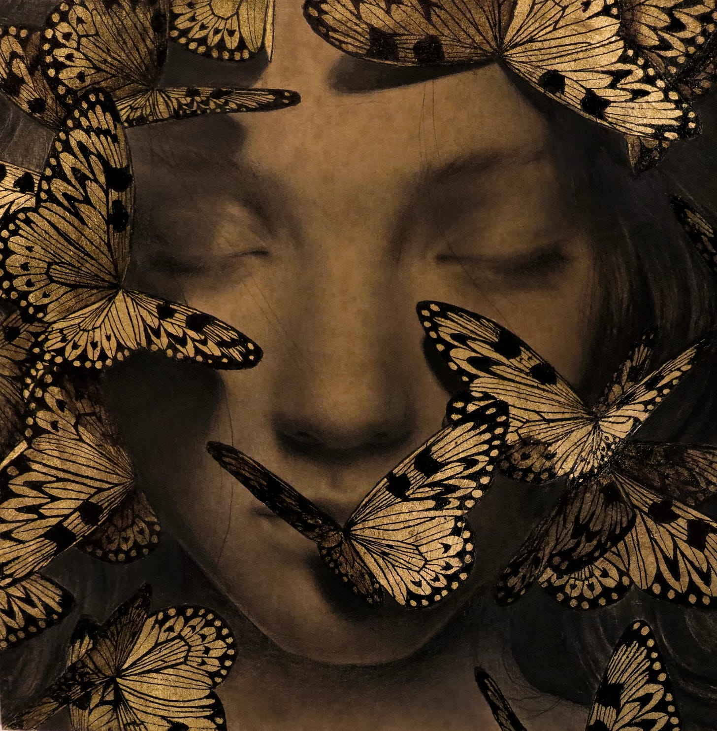 A drawing of a woman's face with her eyes closed and golden butterflies all around her