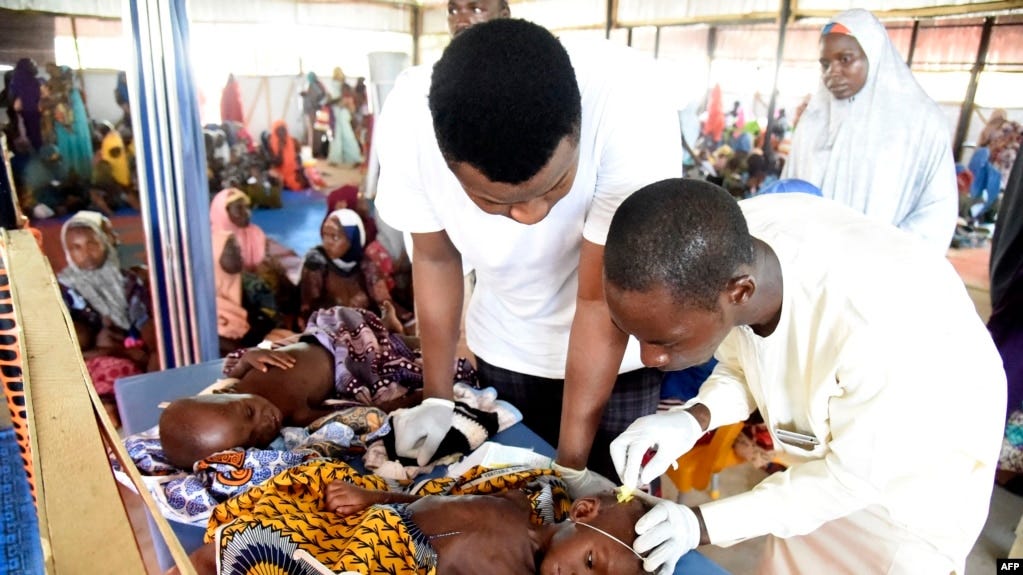 FILE - Health officials attend to children suffering malnutrition in a clinic set up by health authorities in collaboration with Medecins Sans Frontieres or Doctors Without Borders (MSF) at Mashi council of Katsina State, northwest Nigeria, July 22, 2022.