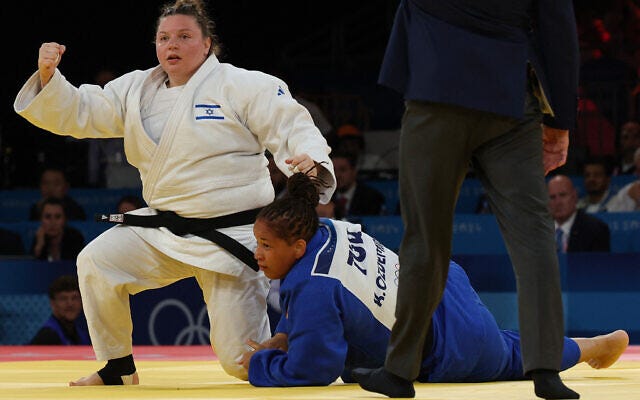 Israel's Raz Hershko reacts after beating Turkey's Kayra Ozdemir (Blue) in the judo women's +78kg semi-final bout of the Paris 2024 Olympic Games at the Champ-de-Mars Arena, in Paris on August 2, 2024. (Jack Guez/ AFP)